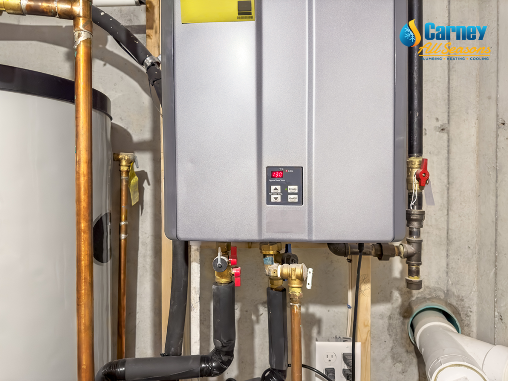 Tankless hot water heater, set to 130° F, connected to a recirculation system and storage tank