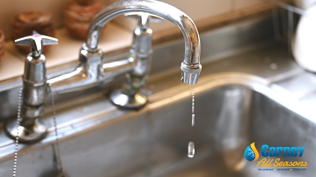 sink and a leaking tap in the kitchen, faulty faucet and water dripping.